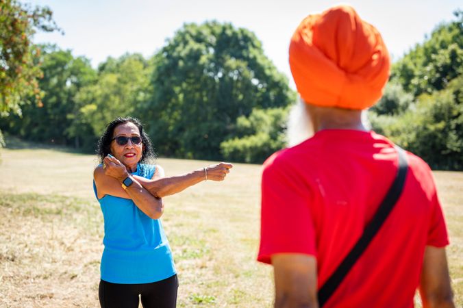 Older Sikh couple stretching