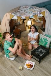 Boy and girl having fun eating marshmallows