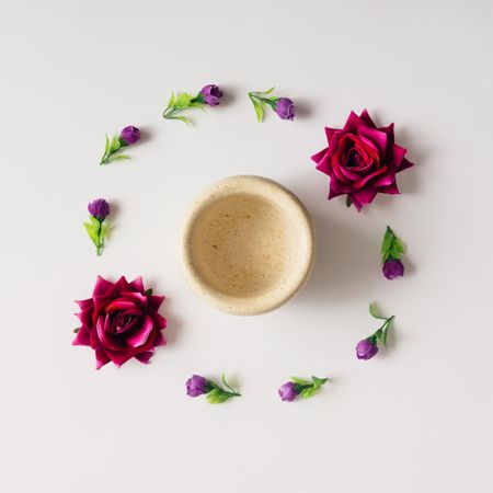 Flowers arranged in circle with coffee mug