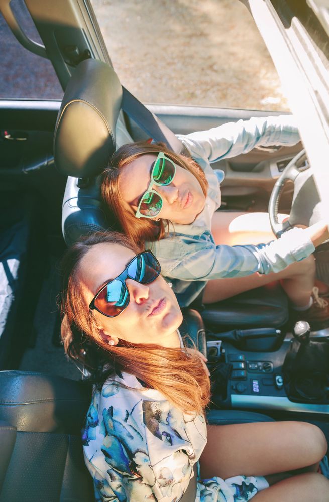 Happy women having fun inside of cabriolet car