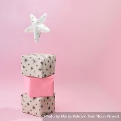 Christmas presents piled on soft pink background 0vZyg0