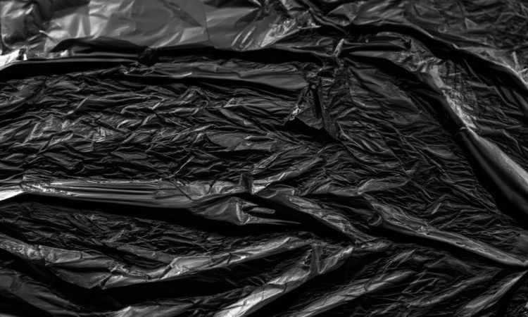 dark crumpled and creased plastic poster texture background