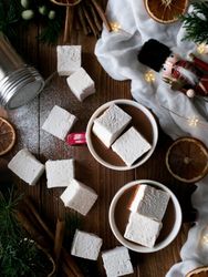 Spices and decorations near hot chocolate with marshmallows