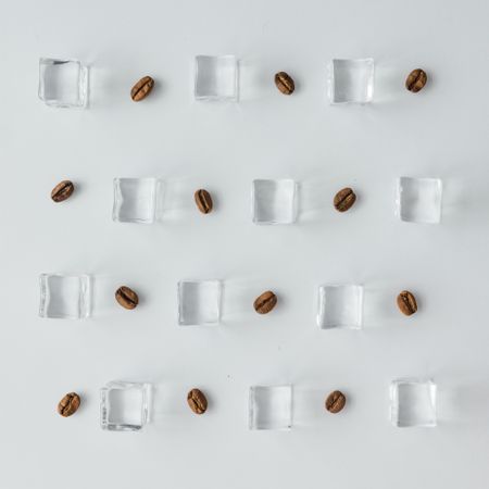 Coffee beans and ice cubes pattern on bright background