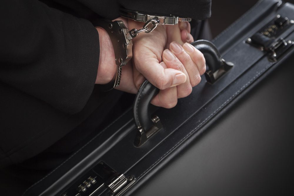 Woman In Handcuffs Carrying Briefcase