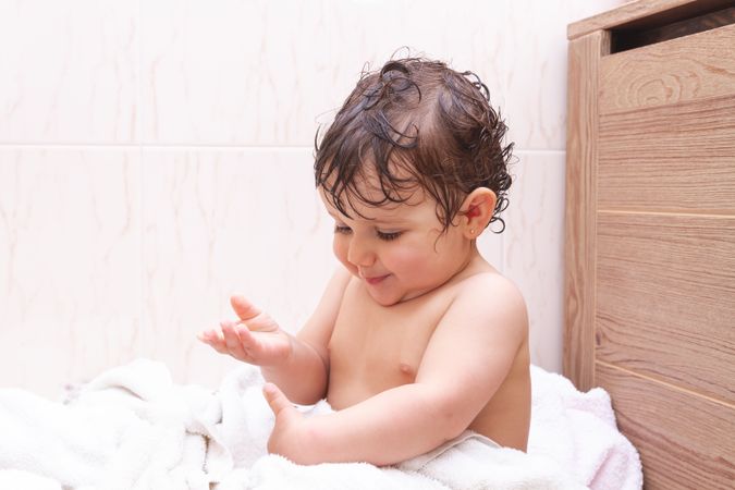 Funny baby in towel after shower