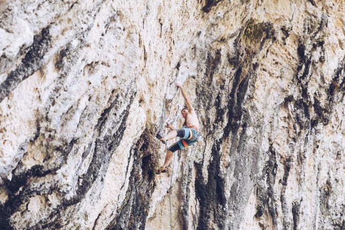 Anonymous man climbing rock