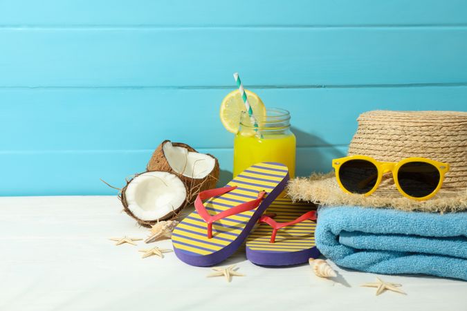 Summer vacation accessories on table against color wooden background, space for text. Happy holidays