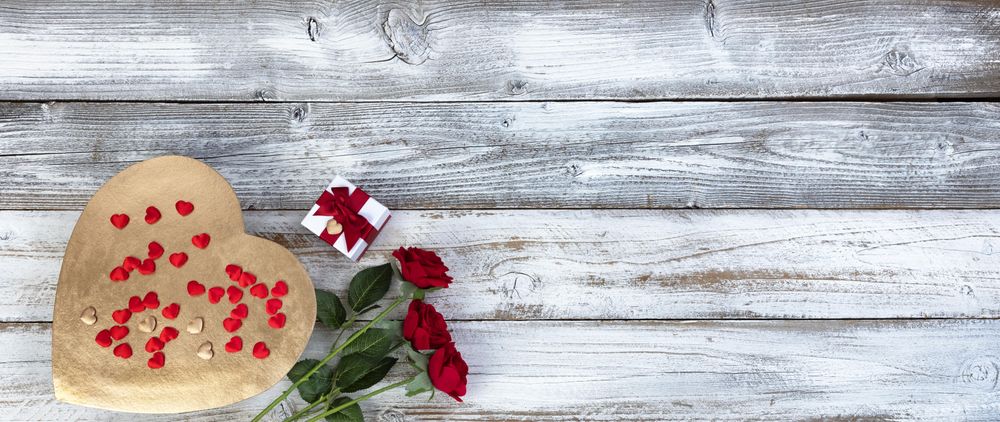 Valentine’s Day Golden heart with gifts on old wood