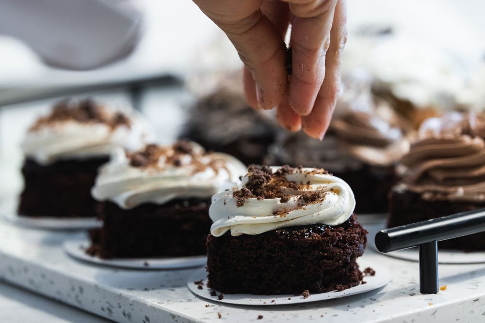 Crop baker preparing vegan dessert in kitchen