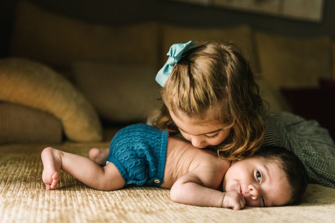 Little girl kissing baby