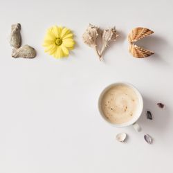 Word “LOVE” made of summer things, with coffee cup, on light background