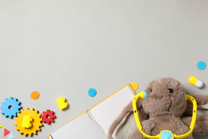 A children's book with toys on a light background.