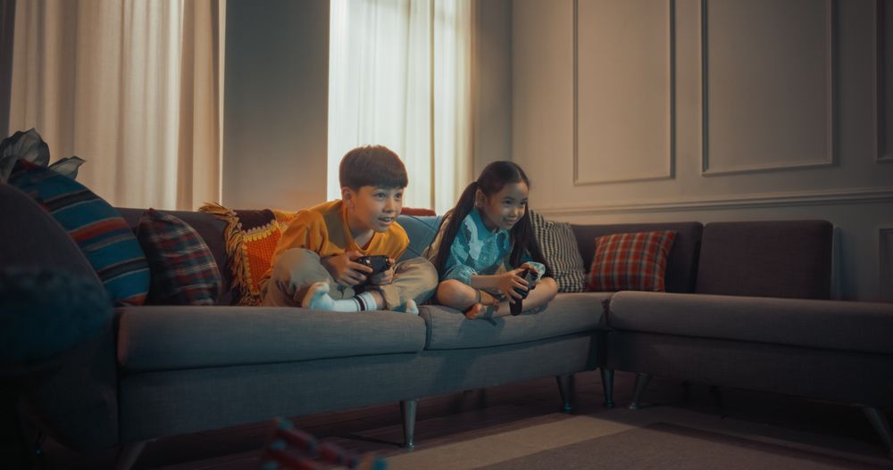 Korean Brother And Sister Enjoying Games Together In The Evening.