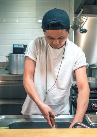 Male washing products for cooking under tap