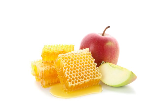 Pieces of honeycomb and apple isolated on blank background, close up