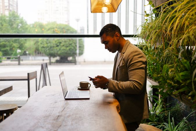Man working on laptop at cafeteria