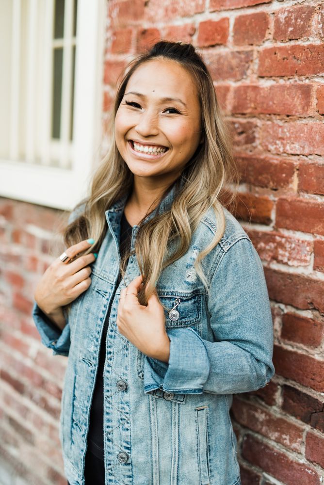 Smiling woman in blue denim jacket