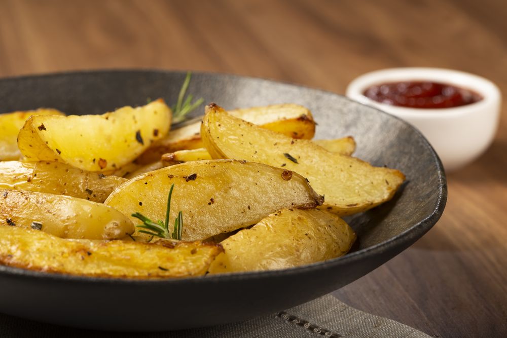 Roasted potatoes with rosemary on the plate.