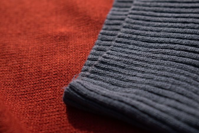 Close up dark grey knitted fabric background texture.