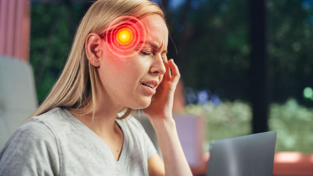 VFX Headache Render: Close Up of a Female Working on Laptop Computer and Experiencing Discomfort and Migraine.