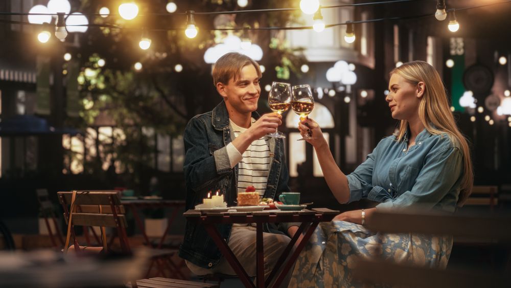 Young Couple is Having a Romantic Date at a Cafe at Night.