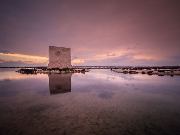 Wonderful watchtower in calm lake on cloudy day