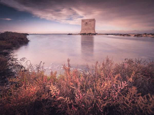 Wonderful watchtower in calm lake on cloudy day
