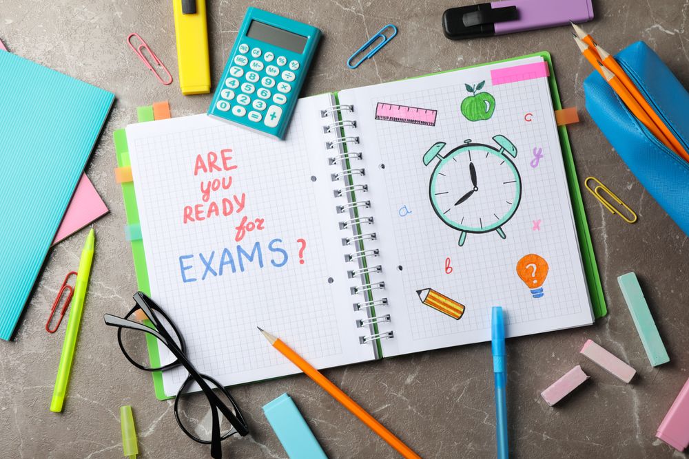 Looking down at open notebook with the words “Are you ready” and drawing of clock