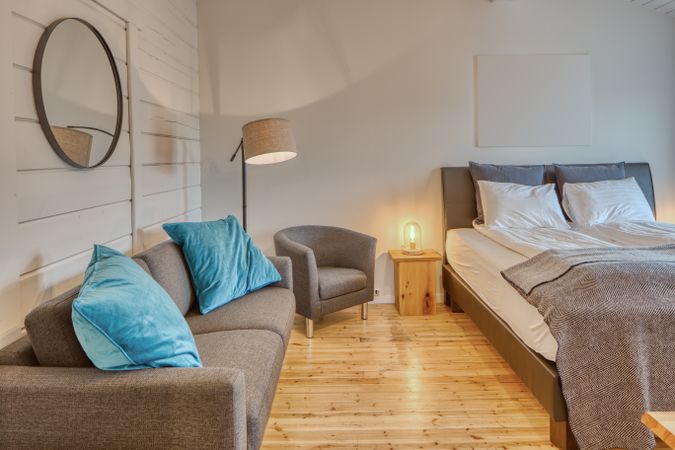 Cozy interior of bedroom with sofa