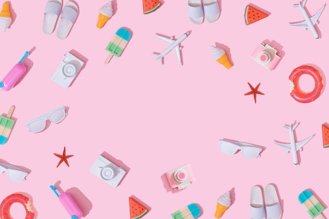 Beach items, like ice cream, camera, airplane, sunglasses, flip flops, bordering pink background