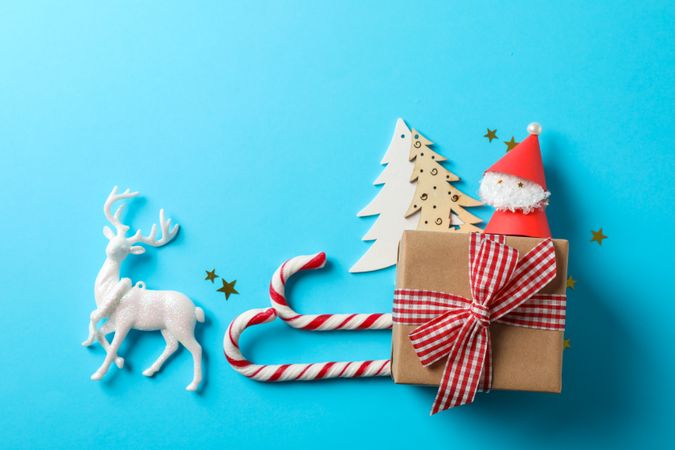 Candy canes and christmas accessories on blue background, space for text