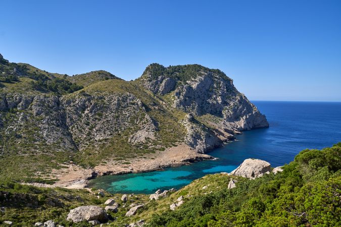 Picturesque view of green cliffs washed by blue sea