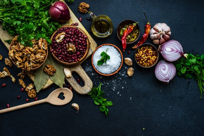 Dried kidney beans and bowls of other ingredients on kitchen counter with copy space