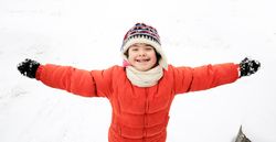 Playful child having fun in the snow