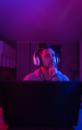 Man listening cheerfully to music with headphones.