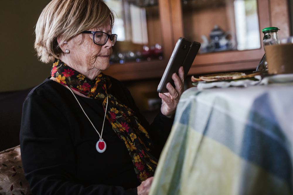 Older woman looking in smartphone