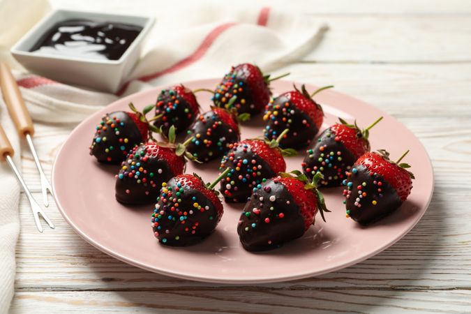 Chocolate fondue. Strawberry in chocolate on wooden background
