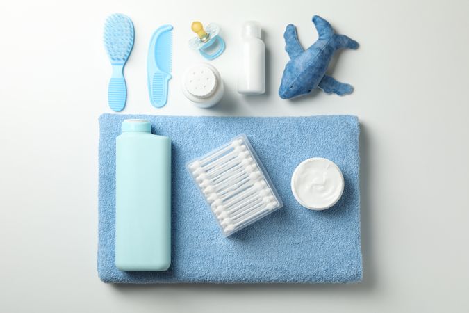 Flat lay with baby hygiene accessories on light background