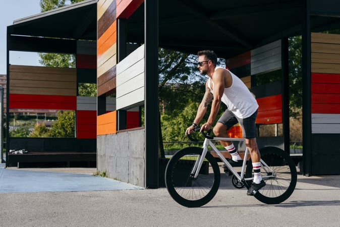 Man riding bike next to buildings