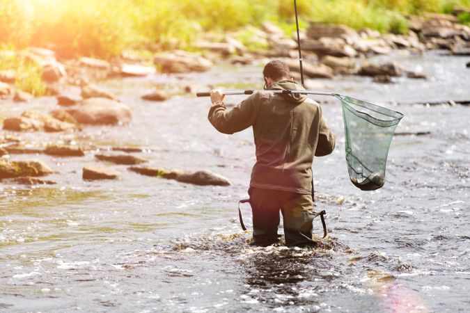 Fisherman Crossing River with Rod