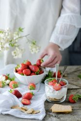 Confectioner cooking dessert of ripe strawberries