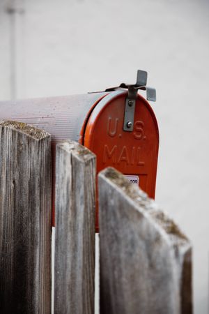Closed mailbox and wooden fence