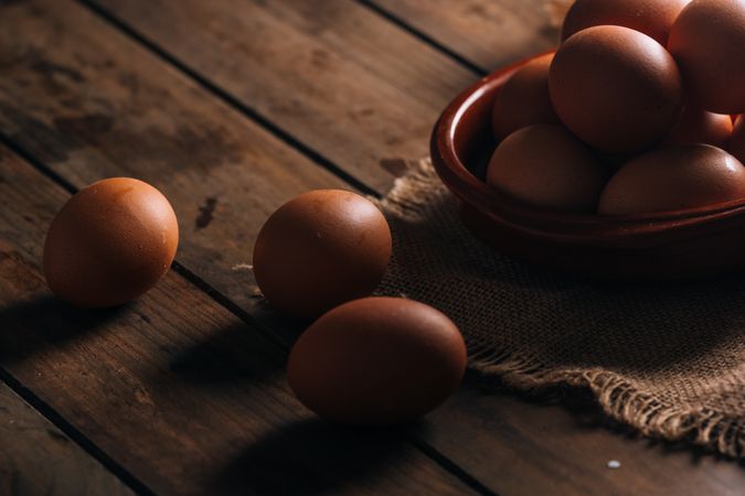 Chicken eggs on napkin on wooden table