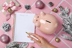 Concept of Christmas finance with piggy bank, top view