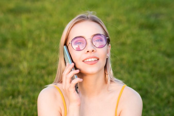 Woman in bright sunglasses talking on phone
