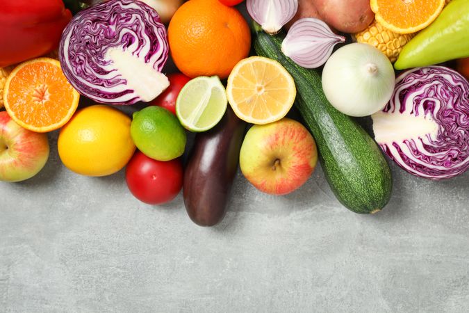 Different vegetables and fruits on grey background, top view