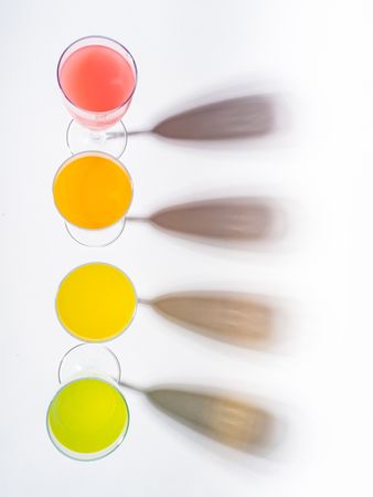Glasses of bright colorful drinks on table