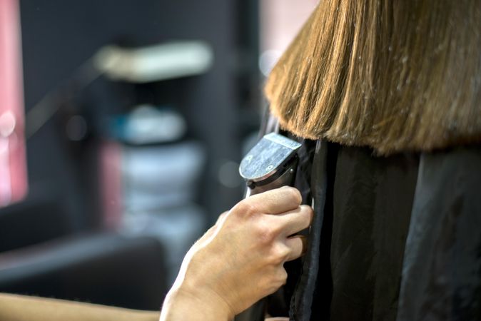 Ends of female hair being trimmed