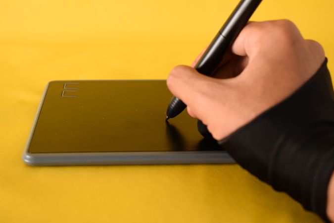 Hand writing on digital tablet with glove and stylus